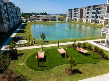 Overhead view of 3 hammocks in front of a pond with fountains at Promenade Luxury apartments in Beaumont, Texas